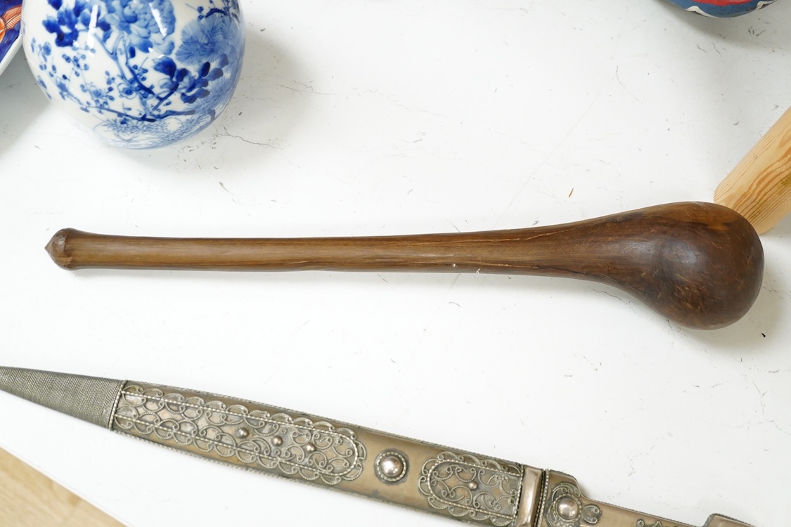 An African hardwood throwing club together with a painted mask and a Caucasian style dagger kindjal, largest 34cm high